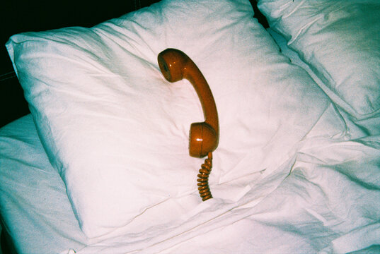 a telephone handset resting on a pillow, 35mm film