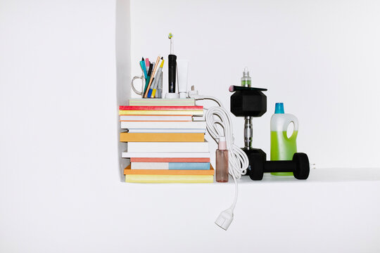 Pile of colourful paper books and everyday life items with flashlight