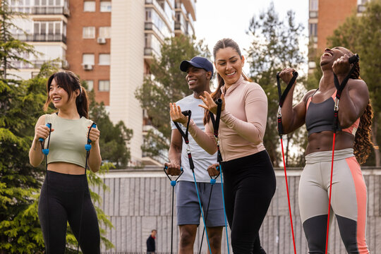 Group exercise with resistance bands outdoors