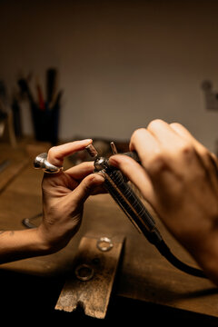 A girl works with a jewelry tool