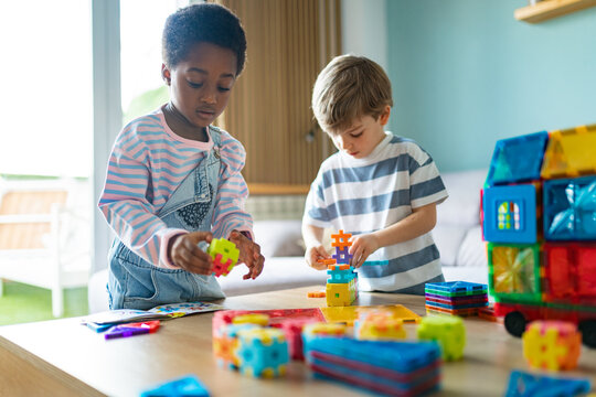 Children playing with colorful creative building blocks toys