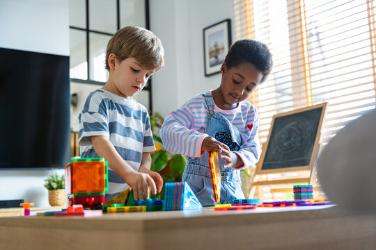 Children playing with construction toys for early education