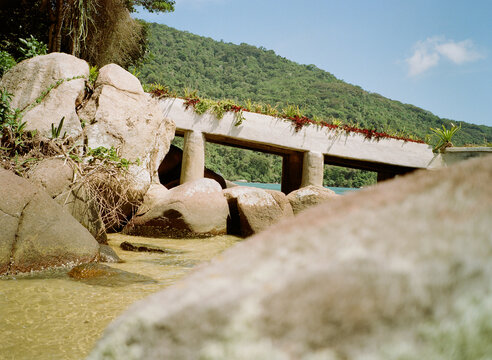 Concrete Pier Connects Land and Water Near Rocky Shore