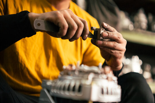 Worker hands assembling an engine part performing an efficient repair