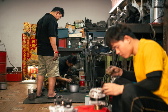 Mechanics diligently assembling engine components in Bangkok