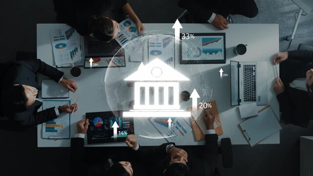 High-angle view of a diverse team engaged in a business meeting, analyzing financial data with visual indicators, laptops, and reports on the table, showcasing collaboration. Raster