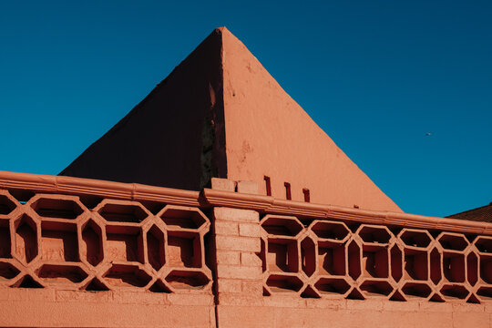 Geometric terracotta facade against deep blue sky