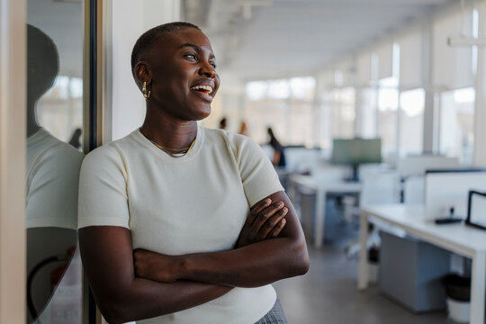 Professional with short hair smiling, looking confident in office