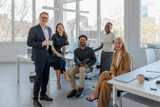 Business team looking at camera at modern office