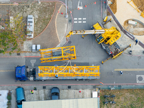 Aerial View of Crane Transport at Construction Site
