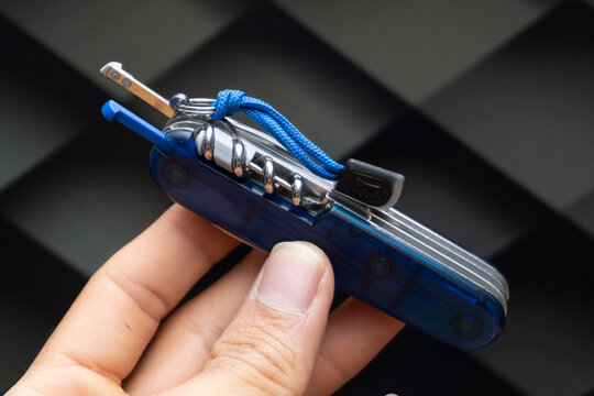 Zapopan Jalisco, Mexico - April 17, 2026: Victorinox multi-tool with toothpick and tweezers partially extended, Victorinox concept