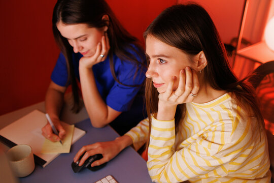Two people working together at desk 