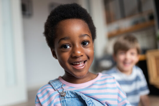 African american child smiling with friend in background