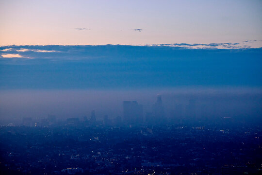 Los Angeles panorama at dusk, shrouded in clouds and haze.