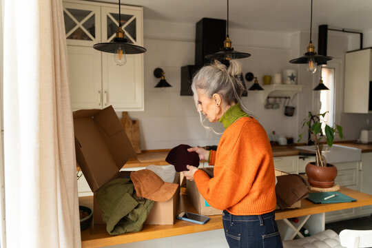 Senior woman unboxing clothes