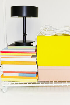 Office items: lamp, books, chargers on a trolley with flashlight