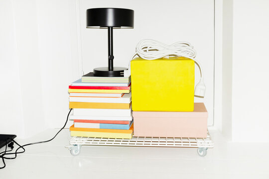 Office items: lamp, books, chargers on a trolley with flashlight