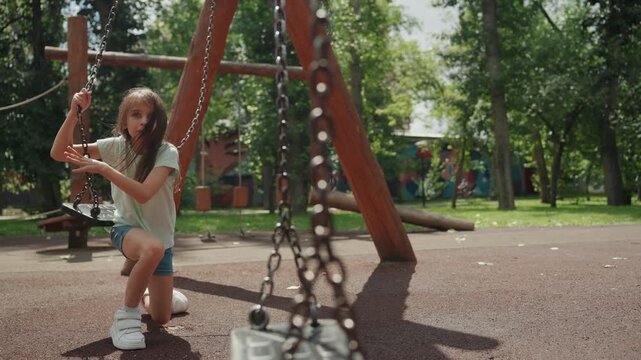 Girl rises again. Young girl falls and quickly resumes playing. Daughter tumbles down but promptly recovers to keep playing. Young girl trips and quickly stands up to continue engaging in play
