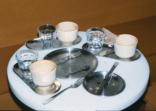 Analog-style close-up, lit with direct flash, of dirty silverware