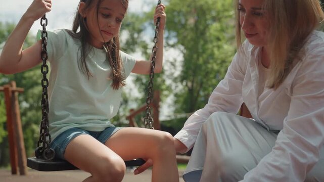 Mother checks wound. Mother examines injury thoroughly. Mother diligently inspects and assesses damage caused by injury. Mother attentively examines site of injury to determine extent of harm