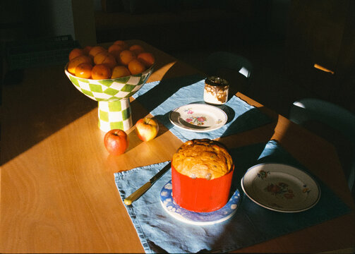 Analog-style close-up of a dining table illuminated by warm sunlight