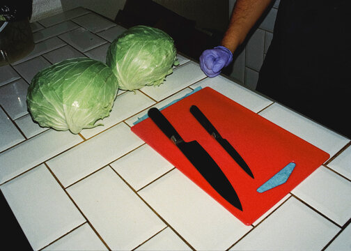 Analog close-up of an unknown chef's workspace to chop fresh cabbage