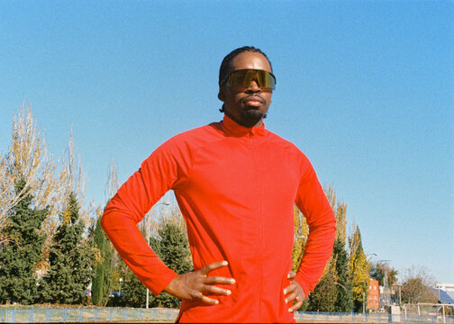 Analog portrait of a confident pro runner wearing sports sunglasses