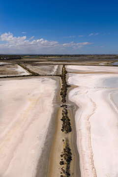 Colorful shoreline patterns and levee banks in a drying salt lakes