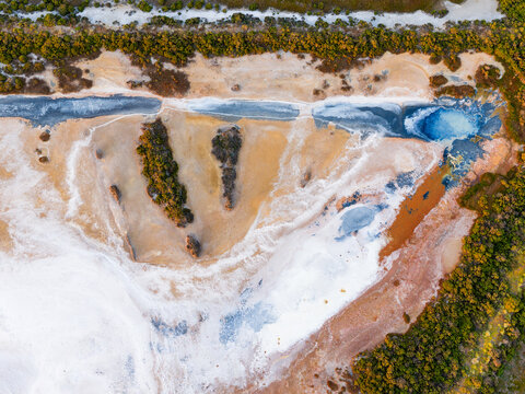 Abstract patterns and textures in a colorful drying salt lake