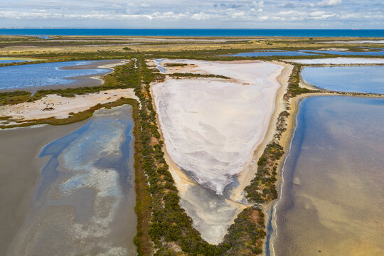 Colorful shoreline patterns and levee banks in a drying salt lakes