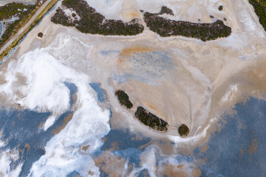 Abstract patterns and textures in a colorful drying salt lake