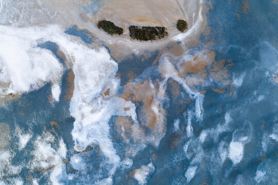 Abstract patterns and textures in a colorful drying salt lake