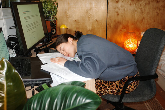 Sleepy person falling asleep during exam preparation
