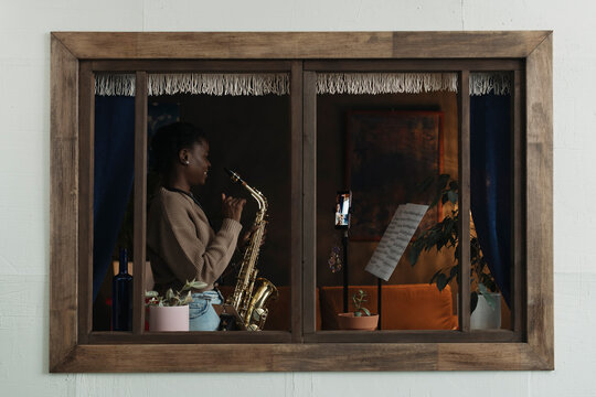 Woman recording her saxophone practice for social media