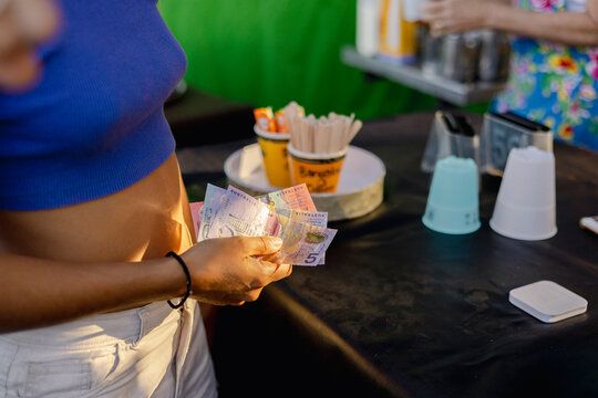 Paying with Cash at Farmers Market in Byron Bay