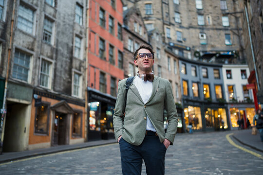 Man stands on street in city
