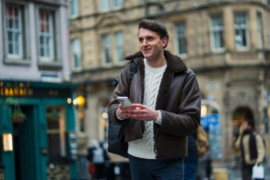 Man using phone in city
