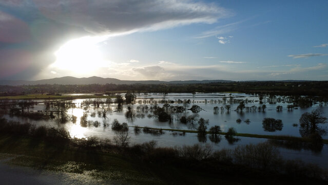 Aerial view of flooded countryside backlighted by winter sun