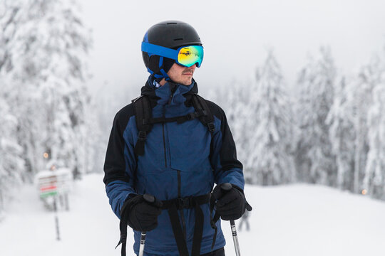 Portrait of a Male Skier in Blue Gear on a Snowy Trail