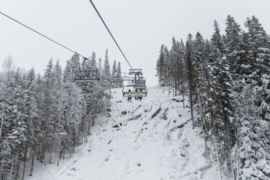 View from a Chairlift Ascending a Snowy Mountain Slope in Winter