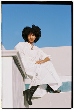 Confident black woman in white dress in Cape Town