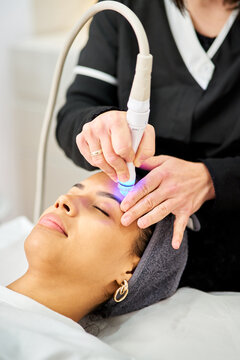 Woman receiving facial skin care aesthetic treatment