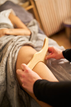 Woman receiving maderotherapy wood massage for body treatment