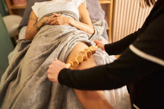 Body carving maderotherapy session on woman's leg