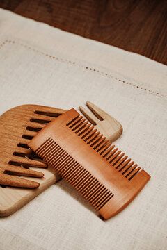 Wooden Combs Placed on a Fabric Surface With Natural Light