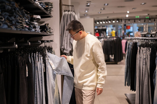 Chinese Man Shopping for Clothes in a Clothing Store 