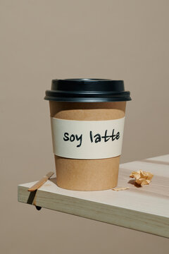 a soy latte cup on a wooden table