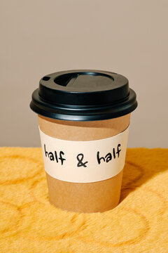 a coffee cup labeled half and half on a plush fabric