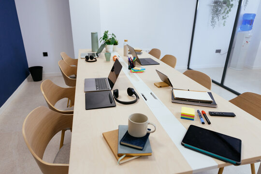 Modern coworking office space with desks and laptops