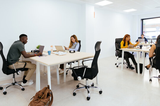 Diverse professionals working in modern coworking office space